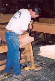 man hand-crafting a beam